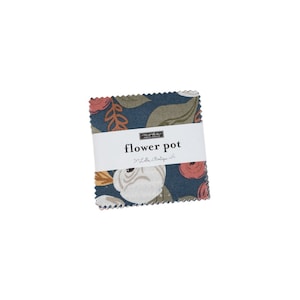 May include: A blue fabric square with a white and orange floral pattern. The fabric has a label that reads "moda fabric" and "flower pot" with the text "Little Boutique" underneath.