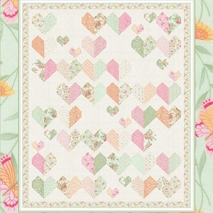 May include: A quilt with a repeating heart pattern in shades of pink, peach, and green. The quilt features the text "Kind Hearts" and "by Coach House Designs". The background has a floral and butterfly design.
