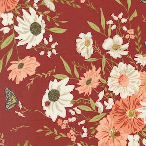 May include: A red fabric with a floral pattern featuring white and peach flowers, green leaves, and a butterfly.