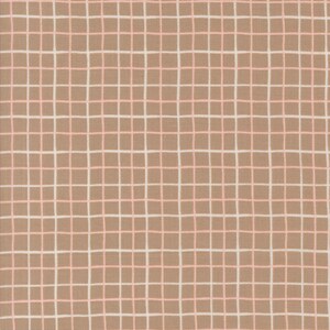 May include: A close-up of a fabric with a grid pattern. The fabric has a tan background with a grid of white and light pink lines. The lines form evenly spaced squares across the surface of the fabric.