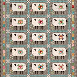 May include: A patchwork quilt featuring a repeating pattern of sheep with heart-shaped designs. The sheep are white with black faces and legs, set against a gray background with blue and white accents. The quilt has a scalloped edge.