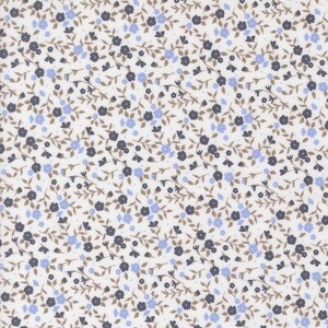 May include: A fabric with a repeating floral pattern. Small, dark blue and light blue flowers are scattered across a white background. Brown stems and leaves connect the flowers, creating a delicate, all-over design.