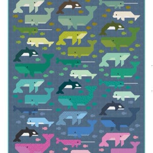 May include: A fabric panel featuring a repeating pattern of whales and fish in various colors, including green, blue, yellow, and pink, on a blue background. The whales are stylized with geometric shapes.