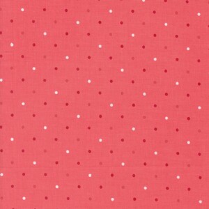 May include: A pink fabric with white and red polka dots.