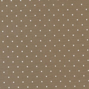 May include: A brown fabric with a white polka dot pattern.