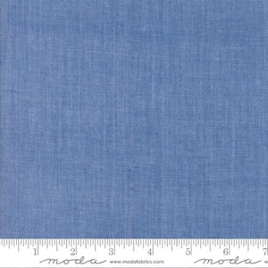May include: A solid blue fabric swatch with a subtle texture. The fabric is measured with a ruler in inches.