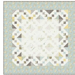 May include: A patchwork quilt with a floral border in shades of blue, yellow, and gray. The quilt features geometric shapes, including triangles and squares, arranged in a symmetrical pattern. The center is a light cream color with a floral pattern.