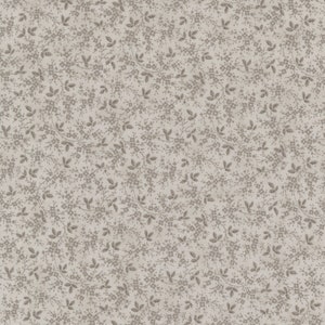 May include: A seamless pattern of small, light brown floral sprigs on a white background. The pattern is repeated throughout the image.