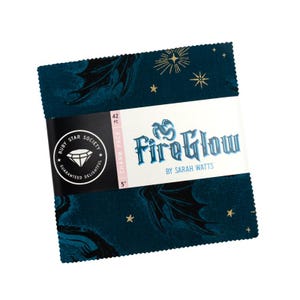 May include: A stack of 5-inch fabric squares from the Ruby Star Society. The fabric has a dark teal background with a repeating pattern of black dragon wings and gold starbursts. The label reads "Fire Glow" by Sarah Watts.