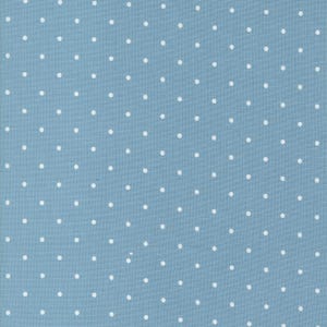 May include: A close-up of a light blue fabric with a repeating pattern of small, evenly spaced white polka dots. The fabric has a slightly textured appearance, suggesting it may be cotton or a similar material. The polka dots are consistent in size and shape.