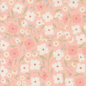 May include: A pink fabric with a repeating pattern of white and pink flowers. The flowers are stylized and have a simple design.