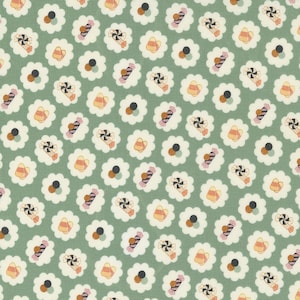 May include: A green fabric with a repeating pattern of white candy corn, pink and brown candy, and black and brown dots. The fabric has a subtle texture.
