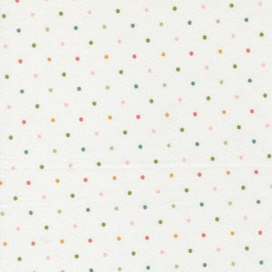 May include: White fabric with a repeating pattern of colorful polka dots. The dots are in shades of pink, green, blue, and orange. The fabric appears to be cotton or a similar material.