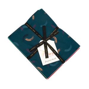 May include: A bundle of four fat quarter fabric pieces featuring a teal background with gold and pink abstract brushstrokes. The fabric is wrapped in a black ribbon with a tag that reads "Ruby Star Society - WI - Sarah Watts - Fat Quarter Bundle".