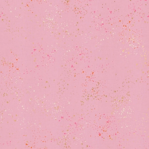 May include: Pink fabric with a speckled pattern. The fabric is a light pink color, and it is covered in small, irregular spots of gold, white, and orange. The spots are scattered across the surface, creating a textured effect.