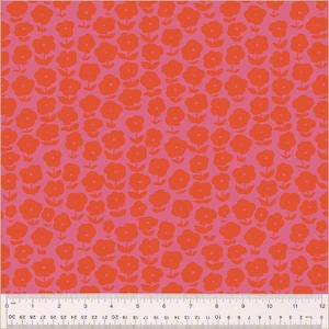 May include: A pink fabric with a repeating pattern of red flowers. The flowers are stylized and have a simple design.