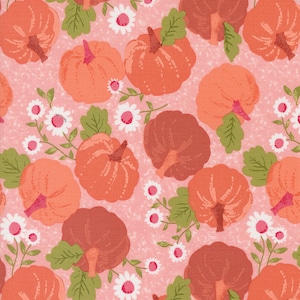 May include: A pink fabric with a repeating pattern of orange and brown pumpkins, green leaves, and white flowers.