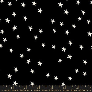 May include: Black fabric with a white star pattern. The stars are of varying sizes and are scattered randomly across the fabric.