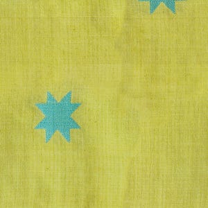 May include: A close-up of a yellow fabric with a repeating pattern of turquoise star shapes. The fabric has a textured appearance, and the stars are evenly spaced across the surface. The overall design is simple and modern.