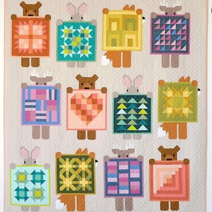 May include: A colorful patchwork quilt featuring whimsical animal figures holding geometric designs. The animals include bears, rabbits, and foxes, each with a unique patterned square. The quilt's background is a neutral beige, highlighting the vibrant colors of the squares.