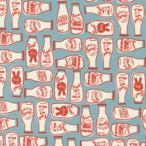 May include: A blue and white fabric with a repeating pattern of milk bottles. The bottles have red lettering and illustrations of farm scenes, cows, and the words "Fresh Milk", "Best Milk", and "Farm Fresh".