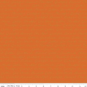 May include: Orange fabric with a repeating pattern of handwritten text in a light brown color.