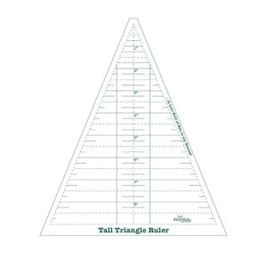 May include: A clear plastic triangle ruler with markings in inches up to 8 inches. The ruler is labeled "Tall Triangle Ruler" and has the text "40 Left Half of Ties in my Bonnet" printed on the side.