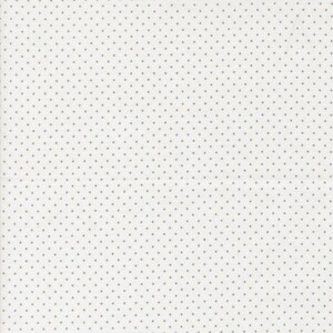 May include: A white fabric with a repeating pattern of small, evenly spaced, light brown dots. The dots are uniformly sized and create a subtle, textured appearance across the surface of the material. The fabric has a clean, minimalist aesthetic.