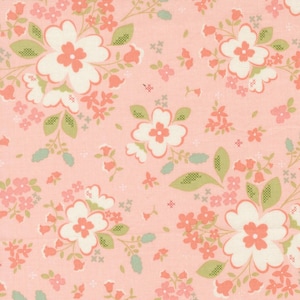 May include: A floral fabric with a repeating pattern of large white flowers with peach centers, smaller peach flowers, and green leaves on a light pink background. The design has a vintage, cottagecore aesthetic.