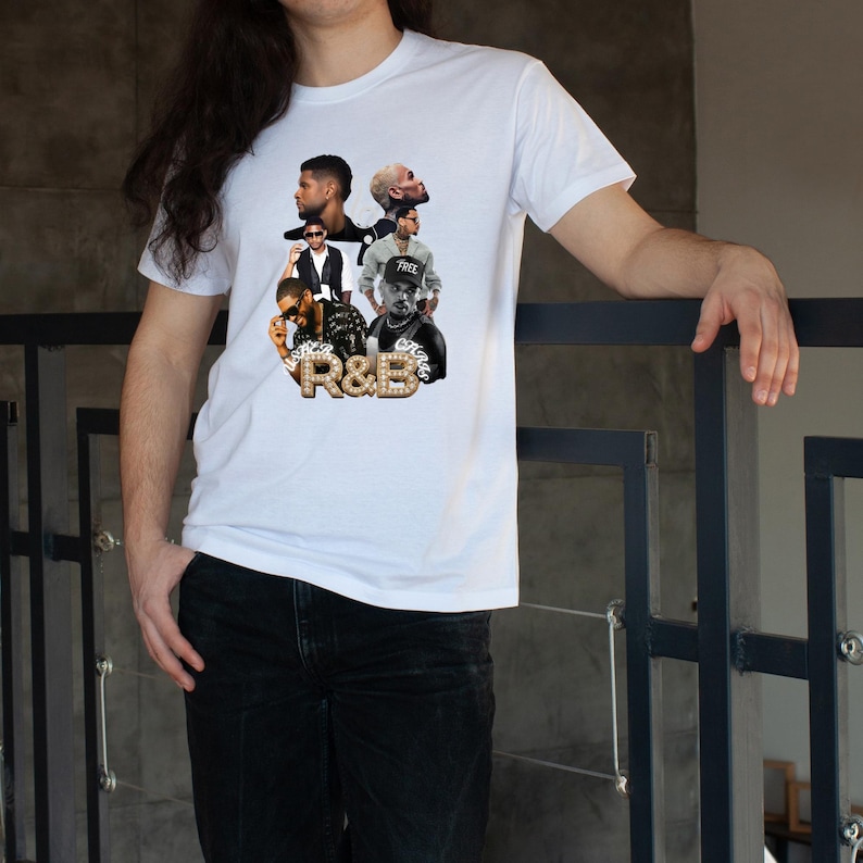 May include: White t-shirt featuring a collage of R&B artists with the text "R&B" in a gold, diamond-studded design. The shirt is a classic crew neck style.