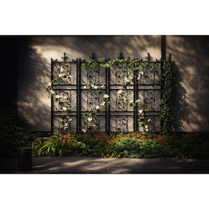 May include: A black wrought iron garden screen with a decorative floral design. White flowers and green vines climb the screen, adding a natural element. The screen is set against a neutral wall with a brick pathway in front.