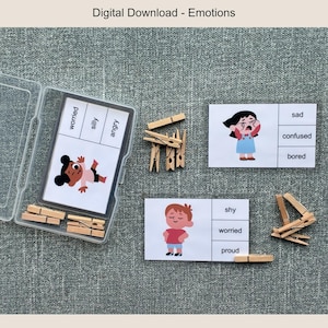 May include: A set of emotion flashcards with illustrations and labels, including "worried," "silly," and "angry." The set includes wooden clothespins and a clear plastic container. The text "Digital Download - Emotions" is at the top.