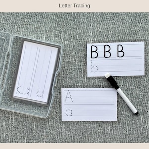 May include: White letter tracing cards with dotted lines and a clear plastic case. The cards feature the letters A and B, with uppercase and lowercase examples. A black and white dry-erase marker is also included.