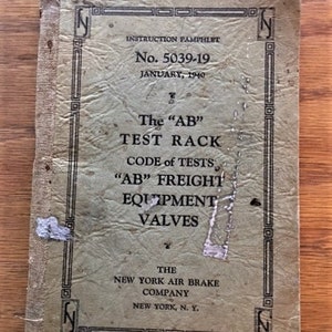 May include: Vintage instruction pamphlet from 1940, titled "The AB Test Rack Code of Tests". The cover is a faded green with black text and decorative borders. The pamphlet is from the New York Air Brake Company, New York, N.Y.