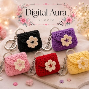 May include: A collection of handmade crochet purse keychains in various colors: black, purple, pink, red, and yellow. Each keychain features a flower embellishment and a silver-tone chain and ring. The keychains are displayed on a light-colored surface.