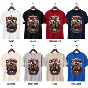 May include: A collection of Croatia t-shirts in various colors, including white, black, cardinal red, navy, natural, sport grey, sand, and royal blue. Each shirt features a graphic with the word "CROATIA" and the year "2026".