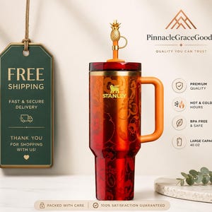 May include: A red and orange Stanley tumbler with a floral design, a handle, and a pineapple-shaped lid. The tumbler has a large capacity of 40 oz. and is BPA-free. The text "Stanley" is visible on the tumbler.