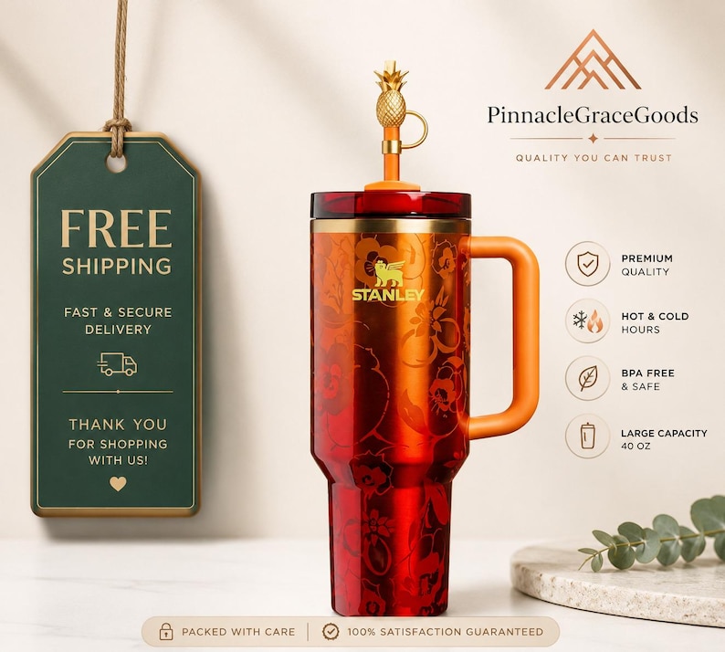 May include: A red and orange Stanley tumbler with a floral design, a handle, and a pineapple-shaped lid. The tumbler has a large capacity of 40 oz. and is BPA-free. The text "Stanley" is visible on the tumbler.
