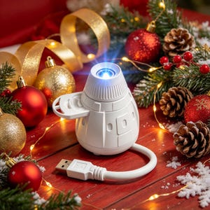 May include: A white, dome-shaped portable projector with a top-mounted lens and a side-extending arm. The device features a smooth, molded plastic exterior and is connected to a white USB cable. It is illuminated with a blue light at the lens.