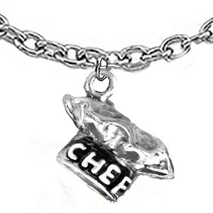 May include: A silver-toned metal charm shaped like a chef's hat, featuring the word CHEF embossed on the front band. The charm is suspended from a silver-toned metal chain link bracelet, showcasing a polished finish and detailed texture.