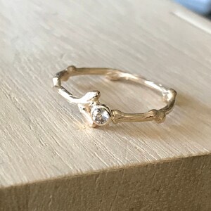 Twig with white sapphire ring in 14k yellow gold