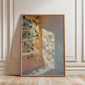 May include: A framed painting depicts a sunlit interior scene. The artwork features a window with hanging green and yellow leaves, casting shadows on the wall. The color palette includes warm oranges, soft blues, and greens.