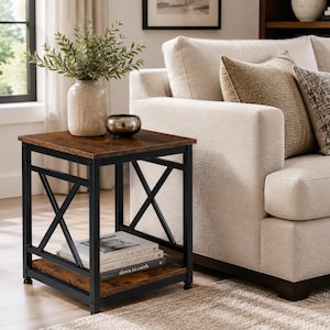 May include: A square side table with a dark brown wood-grain top and bottom shelf, supported by a black metal frame featuring an X-shaped design on the sides. The table holds a textured beige vase with greenery and a small dark metallic bowl.