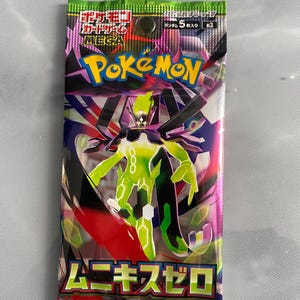 May include: A sealed Pok&eacute;mon card pack with a vibrant design. The pack features the Pok&eacute;mon logo and a green and black character illustration. Text in Japanese is visible. The packaging has a mix of pink, purple, and green colors.