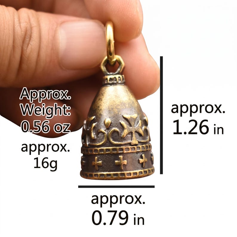 May include: A brass bell pendant featuring a cross and crown motif with a textured finish. The bell measures approximately 1.26 inches in height and 0.79 inches in width, with an approximate weight of 0.56 ounces, as indicated by the text.