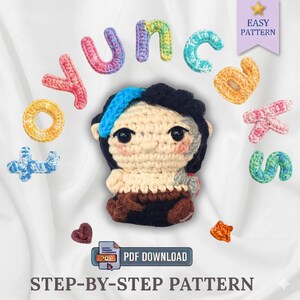 May include: A crocheted doll with a blue streak in its hair, surrounded by colorful crocheted letters spelling "YUNC". The image also includes a PDF download icon and the text "STEP-BY-STEP PATTERN".
