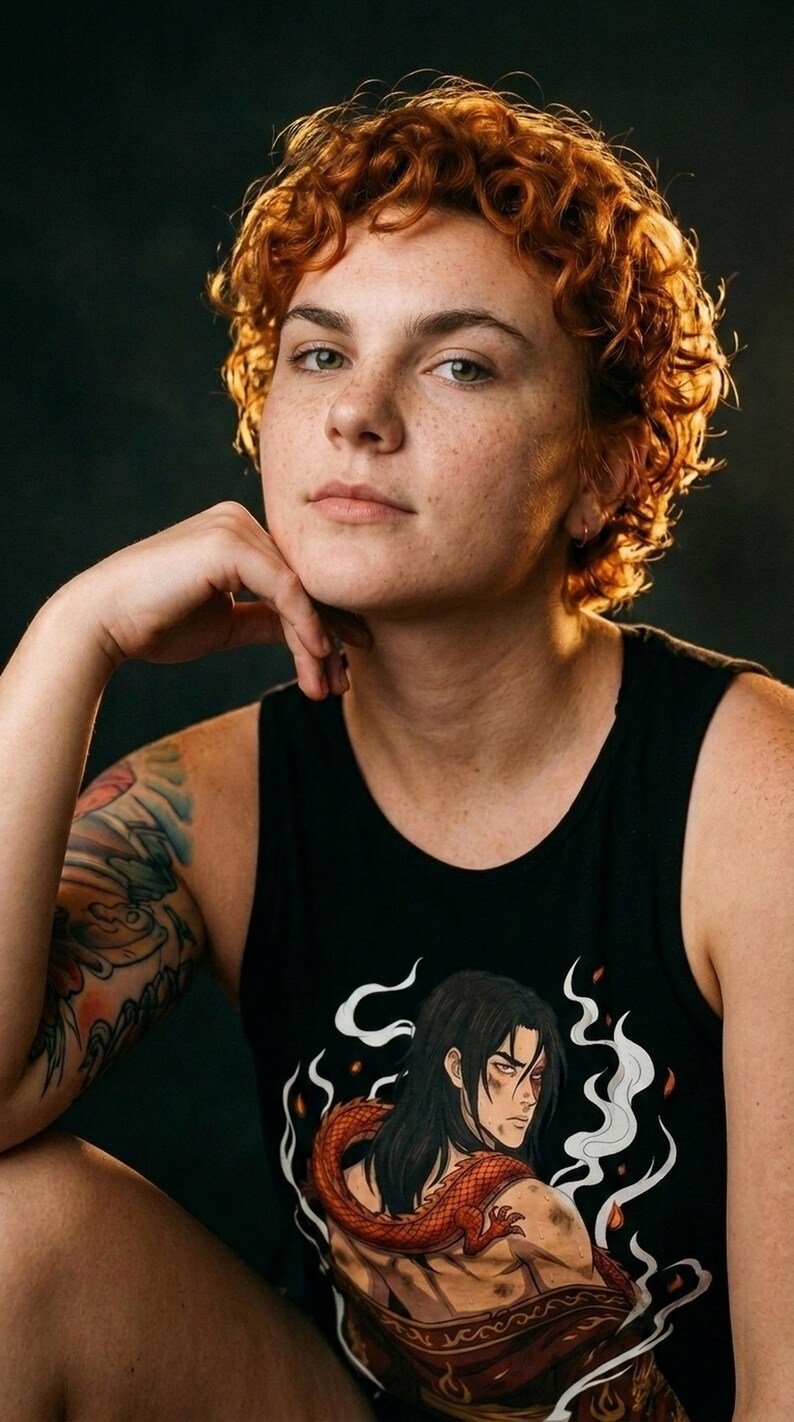 May include: A black sleeveless tank top featuring a graphic illustration of a long-haired character with a red dragon coiled around their shoulders, surrounded by white smoke and flame accents on the front of the garment.