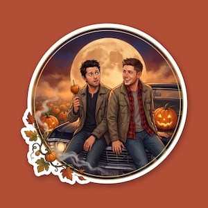 May include: A circular sticker featuring an illustration of two men sitting on the hood of a black car at night. One holds a caramel apple, the other smiles. A large full moon, a glowing jack-o'-lantern, and autumn leaves frame the scene.