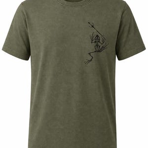 May include: Olive green t-shirt with a black graphic of a frog skeleton holding a spear. The design is on the upper right chest area. The shirt has a crew neck and short sleeves.