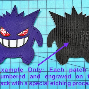 May include: Two embroidered patches in the shape of a cartoon ghost. One patch is purple with red and white details, the other is black. The patches are on a blue grid background. The text on the image says "Example Only: Each patch is numbered and engraved on the back with a special etching process."